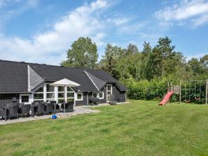 a house with a yard with a playground at Holiday Home Eisa - 300m to the fjord by Interhome in Øsløs +23 photos