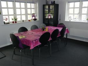 a dining room with a pink table and chairs at Holiday Home Assarina - 300m to the inlet by Interhome in Vinderup