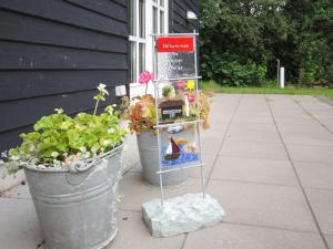 two potted plants and a sign on a sidewalk at Holiday Home Assarina - 300m to the inlet by Interhome in Vinderup