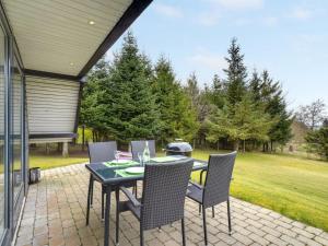 a patio with a table and chairs on a brick patio at Holiday Home Brunhild - 300m to the inlet by Interhome in Fur