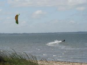 a man kite surfing in the water on the beach at Holiday Home Brynjolf - 350m to the inlet by Interhome in Vinderup +31 photos
