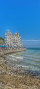 a beach with a ferris wheel and a building at Willesden, Apartment 2, A beautifully furnished and spacious apartment located in the heart of Llandudno in Llandudno +20 photos