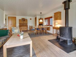 a living room with a couch and a stove at Holiday Home Brimi - 450m from the sea by Interhome in Odder