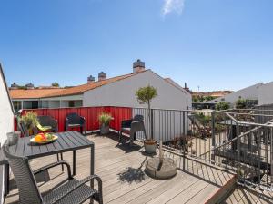 a patio with a table and chairs on a deck at Apartment Elvin - 20m from the sea by Interhome in Ebeltoft