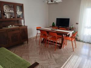 a living room with a dining room table and chairs at CasaLina Apartment in Manduria