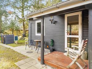 a house with a deck with chairs and a table at Holiday Home Milan - 250m to the fjord by Interhome in Thyholm +22 photos