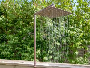 a bird bath with a shower in front of some trees at Holiday Home Eilke - 50m from the sea by Interhome in Rønde