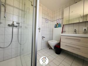 a bathroom with a shower and a toilet at Family M Apartments 40 - Luzern - Horw in Luzern +29 photos