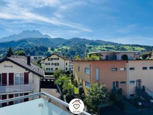 a view from the balcony of a building with mountains in the background at Family M Apartments 40 - Luzern - Horw in Luzern