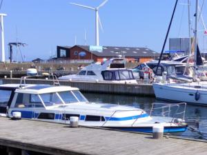 a boat is docked at a dock with other boats at Apartment Line - 10m from the sea by Interhome in Glesborg