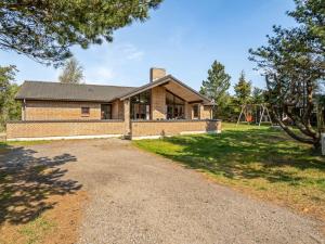 a home with a brick house with a playground at Holiday Home Ehlin - 150m from the sea by Interhome in Sæby