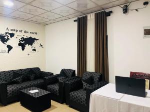 a room with a couch and a table and a map of the world at Premiere Inn Hostel Hiriketiya in Dickwella
