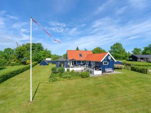 a house with a kite in the yard at Holiday Home Edvia - 700m to the fjord by Interhome in Løgstrup