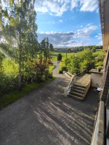a view from the porch of a house with stairs and trees at La clé des champs chambre d'hôtes in Theux