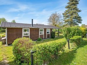a house with a yard with bushes at Holiday Home Teija - 300m from the sea by Interhome in Odder
