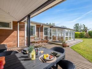 an outdoor patio with a table and chairs at Holiday Home Teija - 300m from the sea by Interhome in Odder