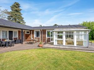 a home with a deck and a house with a solarium at Holiday Home Teija - 300m from the sea by Interhome in Odder