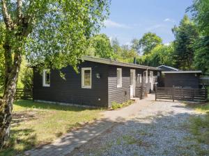 a small black cabin with a tree at Holiday Home Self - 400m to the fjord by Interhome in Løgstrup +31 photos