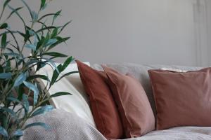 a group of pillows on a couch with a plant at Newcastle City Centre Apartment with Free Private Parking, Walk Away to Quayside in Newcastle upon Tyne