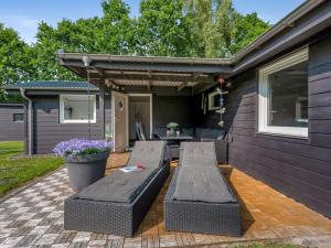 a patio with two couches on the side of a house at Holiday Home Sunja - 450m from the sea by Interhome in Brøndstrup