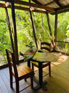 a table and two chairs on a porch with a view at Green Jay Cabins in Duffy Bank +6 photos
