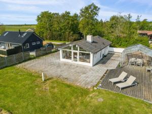 an aerial view of a house with a greenhouse at Holiday Home Gundborg - 100m from the sea by Interhome in Storvorde