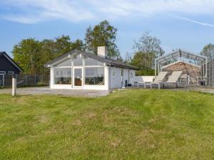a white house with a glass roof on a field at Holiday Home Gundborg - 100m from the sea by Interhome in Storvorde +22 photos