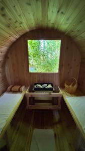 a small room with two beds and a window at Cowichan Valley Retreat with Sauna & Free EV Charger in Duncan