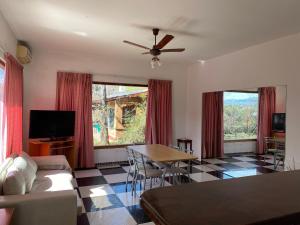 a living room with a couch and a table at Ohana Apartments (solo familias) in Villa Carlos Paz