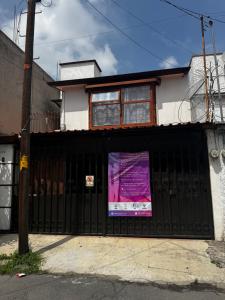 a black fence in front of a house at Casa Pascal in Toluca