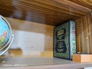 un libro seduto su uno scaffale di Street 7 Apartment a Bahawalpur