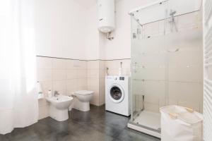 a bathroom with a toilet sink and a washing machine at Relais Seriate,10 min Airport Milano-Bergamo, Parking Free e Air Conditioning in Seriate +14 photos