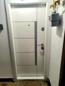 a white cabinet with a door in a room at Relax Apartament Bicaz in Bicaz +12 photos
