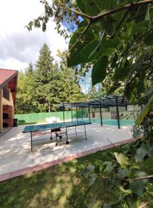 a ping pong table sitting on a patio with at Villa Kamenica in Zavidovići