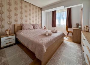 a bedroom with a bed with two candles on it at Luxury Apartment Poli in Ohrid