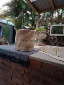 a wicker basket sitting on top of a brick wall at Just Dandee in Naboomspruit