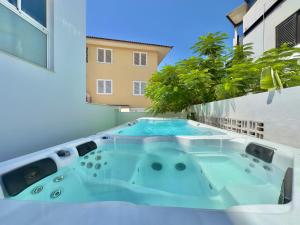 a hot tub on the balcony of a building at The Blue Corner Apartments in Puerto de la Cruz