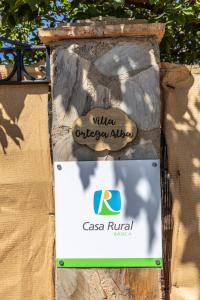 a sign for a building on a stone wall at Villa Ortega Alba in Alcalá la Real