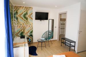 a living room with a tv on a wall at etna sea live catania center home in Catania