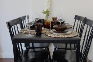 a black table with wine glasses on top of it at Newcastle City Centre Apartment with Free Private Parking, Walk Away to Quayside in Newcastle upon Tyne