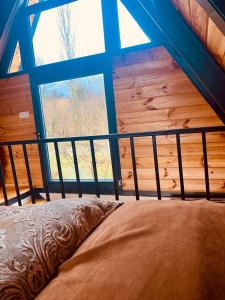 a bed in a room with a large window at Honey Bungalow Kartepe - With Hot Pool in Kartepe