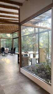 a living room with a large window and a fish tank at Casa completa con piscina - Casa Dorotea in Macas