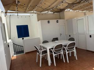 a white table and chairs in a room at Apartamentos Burgao in Caleta de Sebo +67 photos