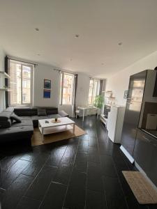 a living room with a couch and a table at Cozy room in the heart of Marseille in Marseille