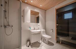 a bathroom with a toilet and a sink and a shower at Levi Nordic Light in Levi +19 photos