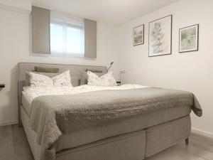 a bedroom with a large bed with white sheets and pillows at Ferienwohnung Wagner in Bad Staffelstein