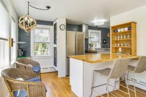 a kitchen with a counter and some chairs in it at Bocce Court and Outdoor Shower Cape Cod Retreat! in Colonial Acres