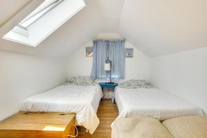 a room with two beds and a couch at Bocce Court and Outdoor Shower Cape Cod Retreat! in Colonial Acres