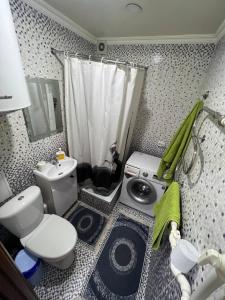 a small bathroom with a toilet and a sink at Вип Квартира посуточно in Shakhtīnsk