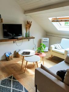 a living room with a couch and a table at Studio 14 Un véritable cocon en Centre Ville in Bagnères-de-Bigorre